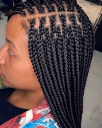 a woman with braided hair in a salon